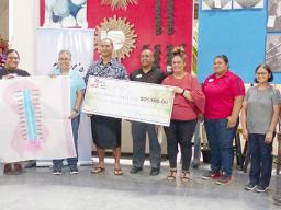 American Samoa Community Cancer Coalition board chairman, Taotasi Archie Soliai  accepts donation from Neil's Ace Home Center