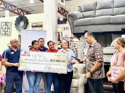 Ngaire Ho-Ching presenting check  to Toetasi Archie Soliai