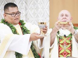 Deacon Ese’ese Tui assists Bishop Larry Silva
