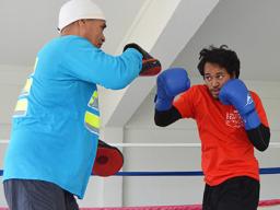 Trainer, Sala Senele Etuale hitting the pad with one of the local boxers 