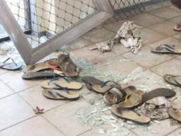 Broken glass and scattered slippers