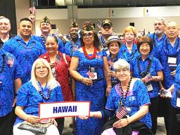 Igafo Maria Brown Va’a (middle holding US flag with red lei) along with the Hawaii Veterans of Foreign War delegation