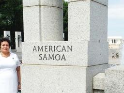 Congresswoman Uifa’atali Amata next to American Samoa pillar