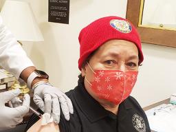 Amata getting vaccinated while wearing a mask