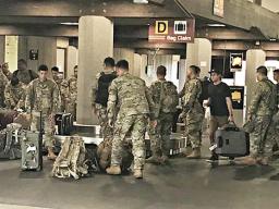 Some of American Samoa’s 100th Infantry Battalion 442nd Regiment picking up their luggage at the Hilo airport