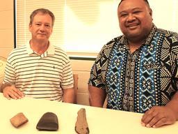 Earl Andersen (left) and Territorial Librarian, Justin Maga pictured yesterday at the Feleti Barstow Public Library where Andersen, on behalf of the Rev. Fred Andersen family, returned to the territory what appear to be stone artifacts 