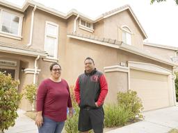 Makerita Iosefo-Va'a and her husband Shaun Va'a pose in front of a relative's home