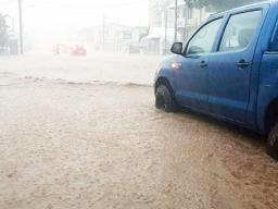 Car stalled on flooded road in Apia