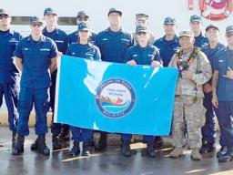 Maj. Julius Delapena pictured with crew members of the U.S. Coast Guard Cutter Oliver Berry
