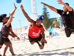 Two members (left and right in black) of the American Samoa National Men’s Beach Handball Team