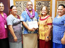 Dr. Rosevonne Pato (2nd left) and ASCC administrators celebrate with Dr. Kamo Koloi (center) 
