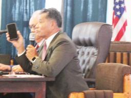 Homeland Security director Samana Semo Ve’ave’a holds up an iPhone