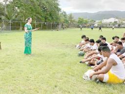 Marian McGuire Ale speaking to Leone football players 