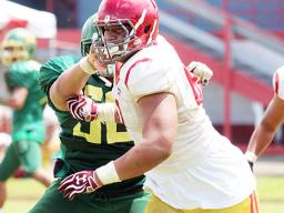 Tafuna Warriors Sophomore Francis Mauigoa breaking through Leone Lions wall
