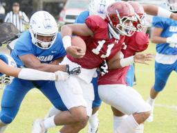 Tafuna Warriors ball carrier trying to escape Samoana’s defenders 
