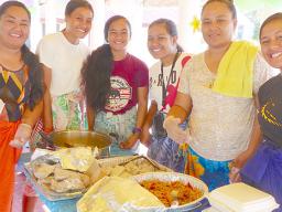 Array of yummy food with young ladies serving