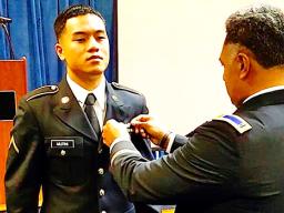 PV2 Nikolao II Chacko Mutini having his wings pinned on by his brother John.