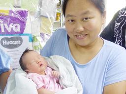 Mrs. Mrs Zhang Chao Jun and her New Year baby