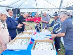 Veterns cutting the cake at a Pre-Veterans Day block party