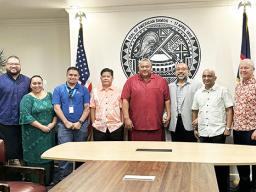 Gov. Lemanu P.S. Mauga and ASG staffers in a group photo with personnel from Bluesky and its parent company