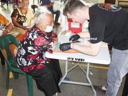 Woman having her blood drawn at Brain Health Fair