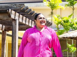 Aigalesala Toelupe in pink wearing her creation