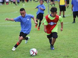 A Black Roses player (left) and Lion Heart opponent battle for possession 