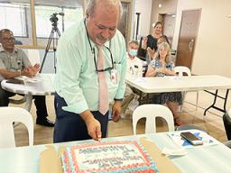 CEO Moefa'auo William Emmsley cuts cake