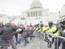 Trump supporters try to break through a police barrie