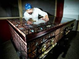 Artist and signage Specialist Pomare Amosa with one of the caskets he has decorated