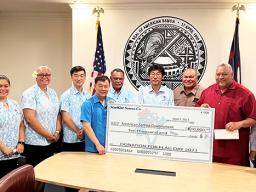 StarKist CEO Chae- Ung Um presents $10,000 check