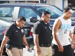 Chanel Lafua handcuffed with police guards