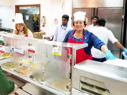 Amata serving food to the troops in Kuwait over the Christmas holiday