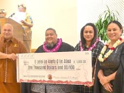 Chief of Staff Loa Tuimavave T. Laupola presents check 