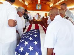 Pallbearers escorted into the Futiga Catholic Church last Thursday during the family service, the U.S. flag-draped coffin of  Ulufaleilupe Fuimaono Ta’aala Leulua'ialii Filifaiesea Fa'asuamalie