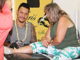 Christopher Adolfo Krieg smiles for the Samoa News Camera while tattooing a tourist