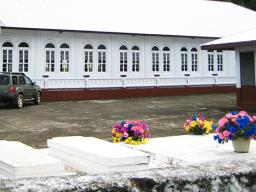 graves near a house and church