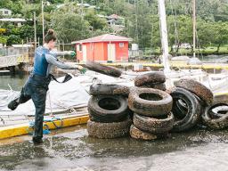 Stacking up tires cleaned up from the bottom of Malaloa Marina