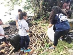 Students during a clean up project along the Pala Lagoon shoreline in Lions Park