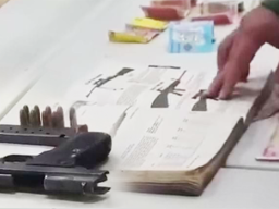 Iraqi money, illegal guns and ammunition, as well as a hardcover book with descriptions of various guns
