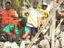 CJ Construction crew building a rock wall