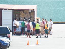 Port workers and Customs officers inspect a mixed cargo container.