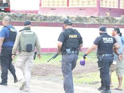 Police officers leading a suspect away 