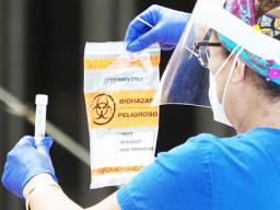 Healthcare worker with COVID-19 test kit