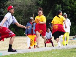 Teammates running after one of the women hit the ball 