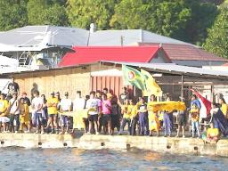 crowds of supporters lining the shoreline