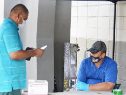 Customs agent inspecting a package of person picking up at post office