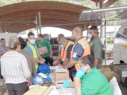 Custom's officers screening cargo off Lady Naomi