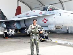 Daniel McMoore with a U.S. Navy fighter jet