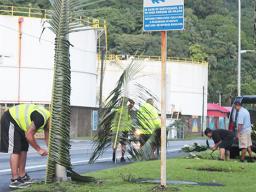 Customs personnel decorating for Flag Day across from the tank farm.